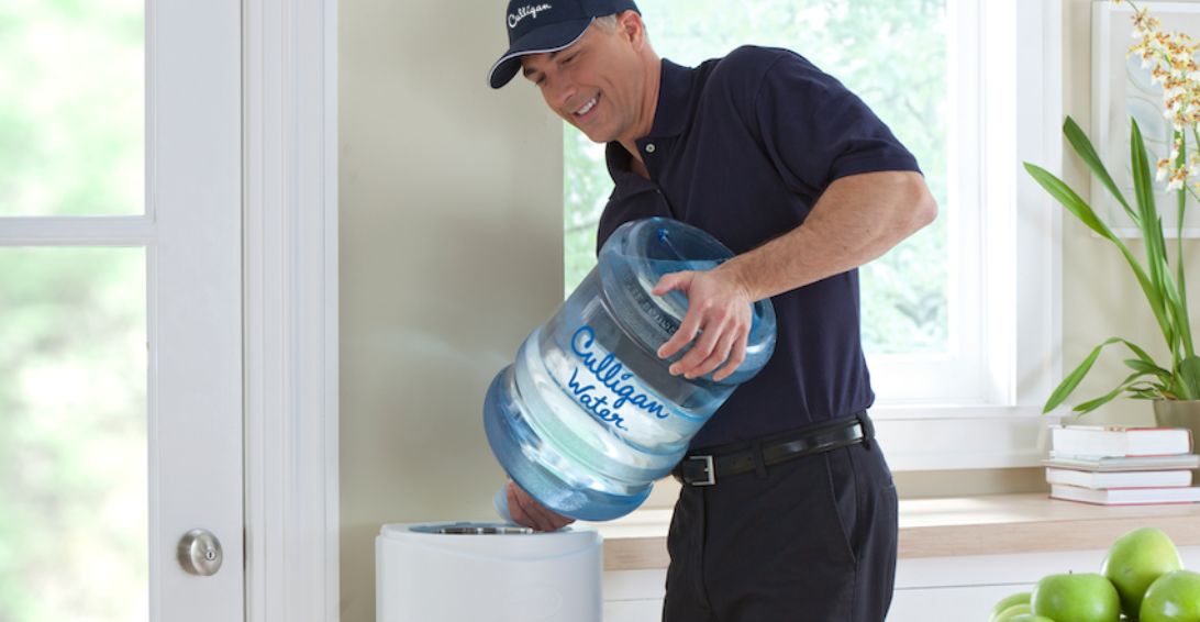 Culligan Man replacing bottled water cooler
